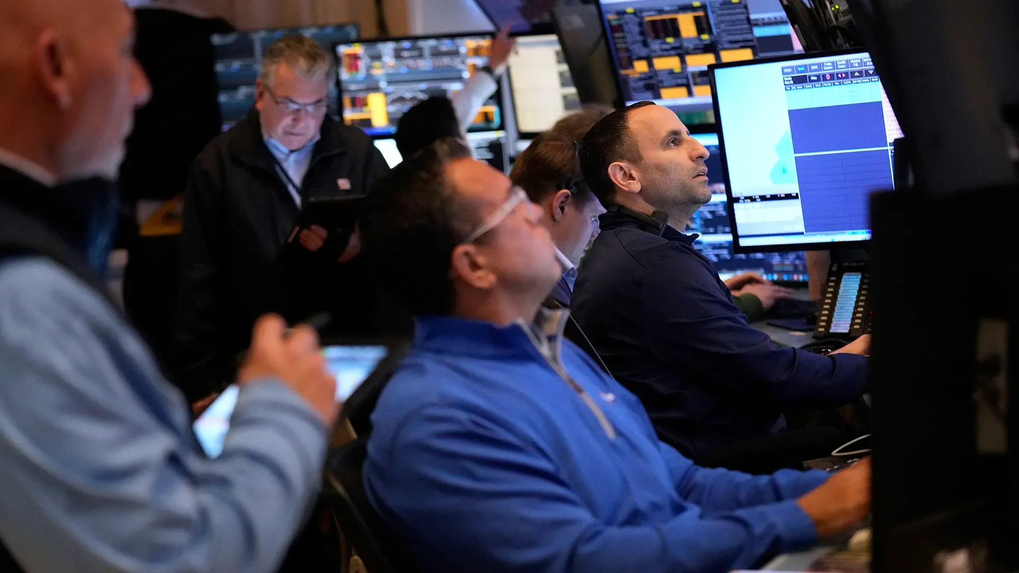 تداول المستثمرون في وول ستريت، مع التركيز على شاشات البيانات المالية، وسط تراجع الأسواق بسبب المخاوف الاقتصادية.