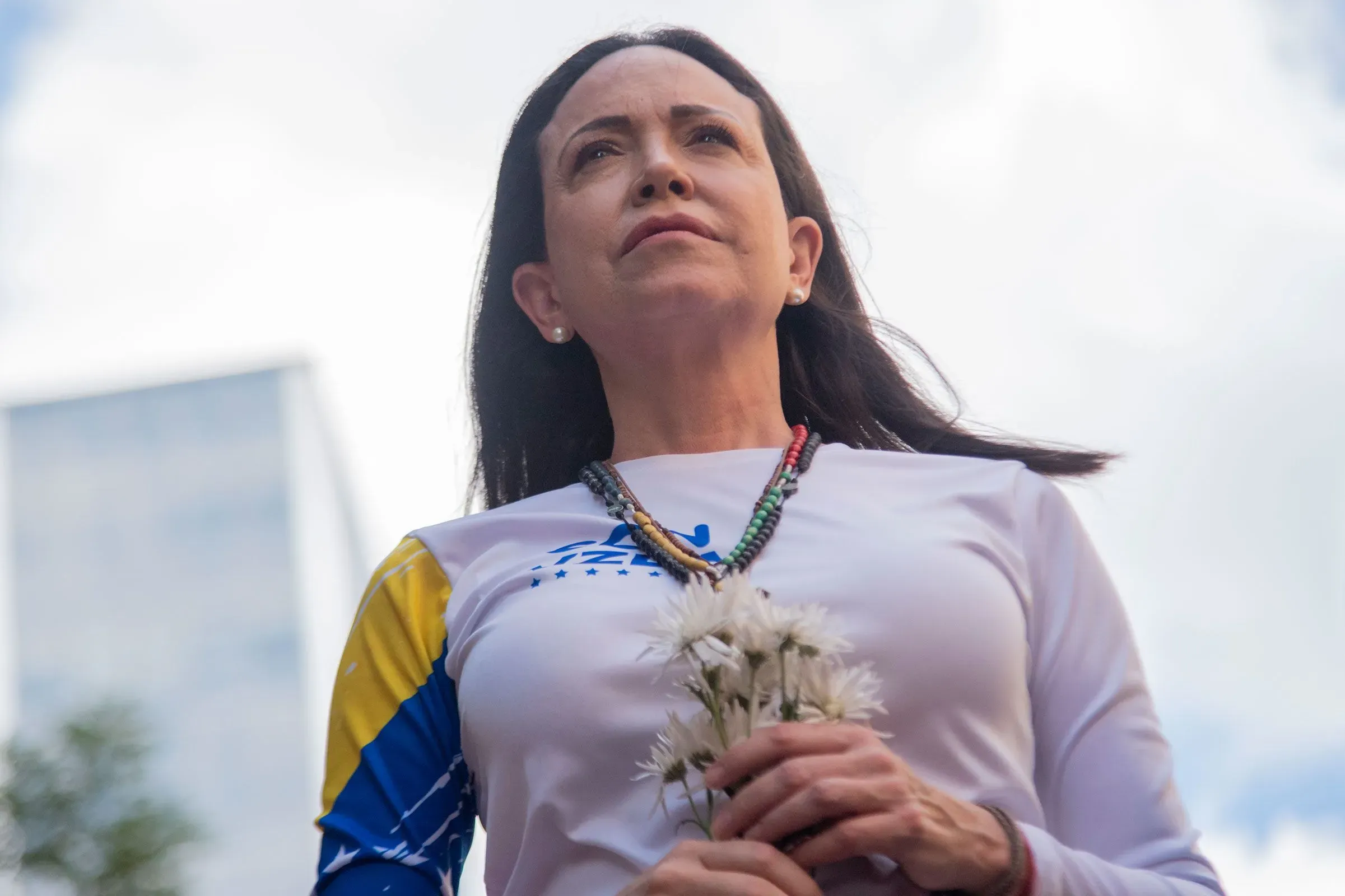 ماريا كورينا ماتشادو تحمل الزهور، تعبيرًا عن الأمل في حقبة جديدة لفنزويلا، بينما تتطلع نحو المستقبل بعد فترة حكم مادورو.