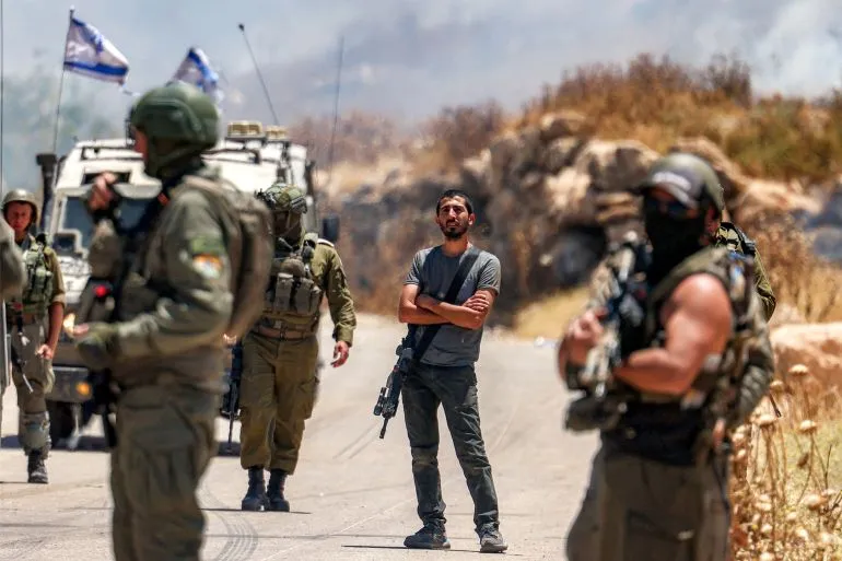 تظهر الصورة مجموعة من الجنود الإسرائيليين في مواجهة شاب فلسطيني، في سياق التوترات المستمرة بالضفة الغربية.