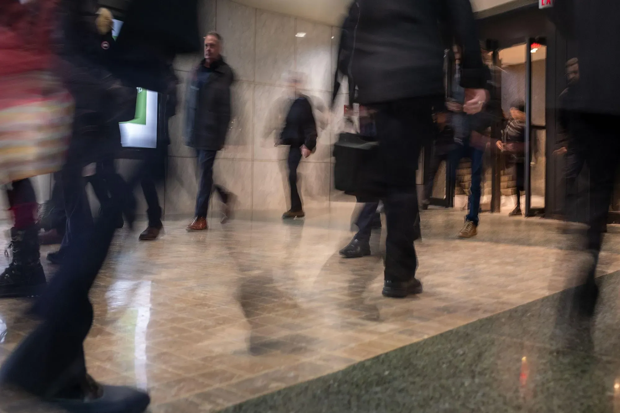 ممرات PATH في تورونتو تعج بالناس في يوم شتوي، حيث يتنقل الموظفون بين المكاتب والمتاجر بعيدًا عن البرد القارس.